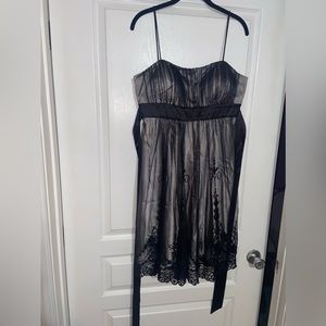 New, no tags- woman short dress sz 12 in color black lace and silver polyester.